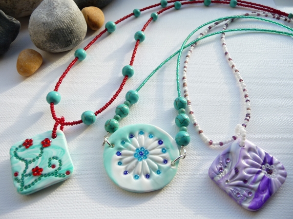 a-selection-of-handmade-polymer-clay-pendant-on-beaded-necklaces-georgia-p-designs