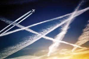 4434143 aeroplane and aircraft jet trails in sky-large